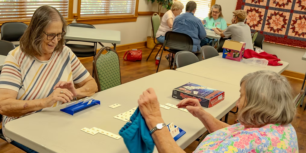 Seniors playing Rummikub together at a table